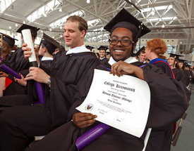 A graduate displays his diploma.