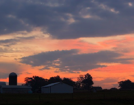 Sunset behind a barn