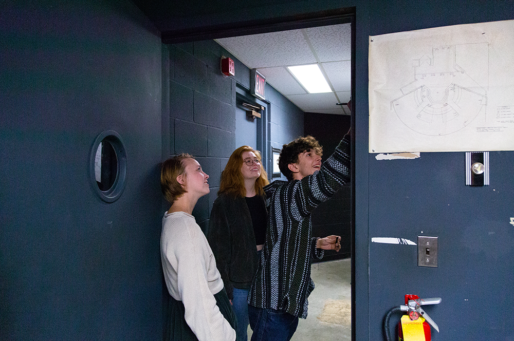 Stage manager and two others writing backstage