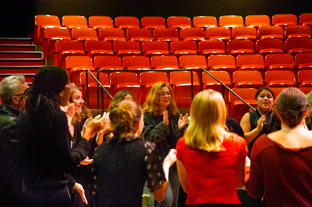 Actors clapping in a circle